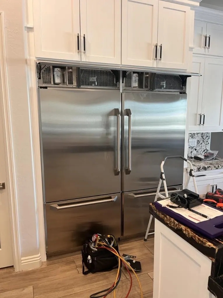 Inside view of a refrigerator during component replacement